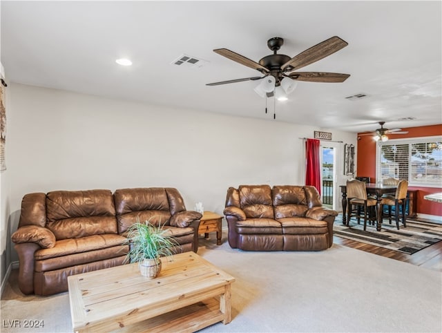 living room with ceiling fan and light hardwood / wood-style floors