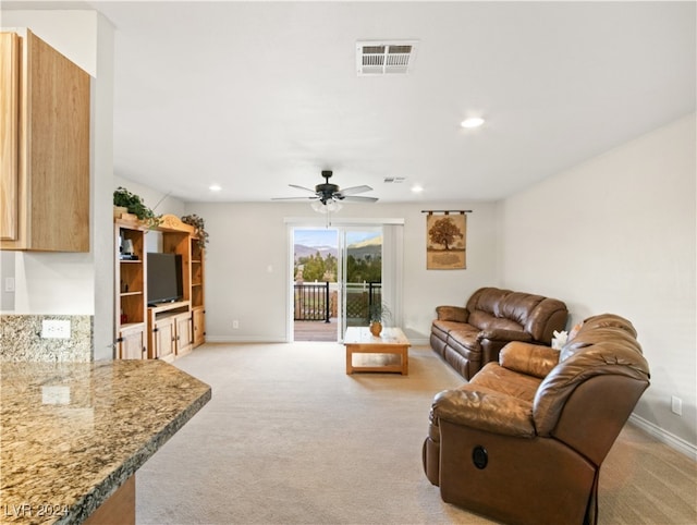 living room featuring ceiling fan and light carpet