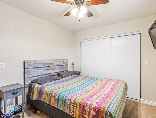 carpeted bedroom featuring ceiling fan and a closet