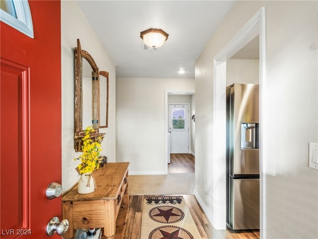 hallway with light hardwood / wood-style floors