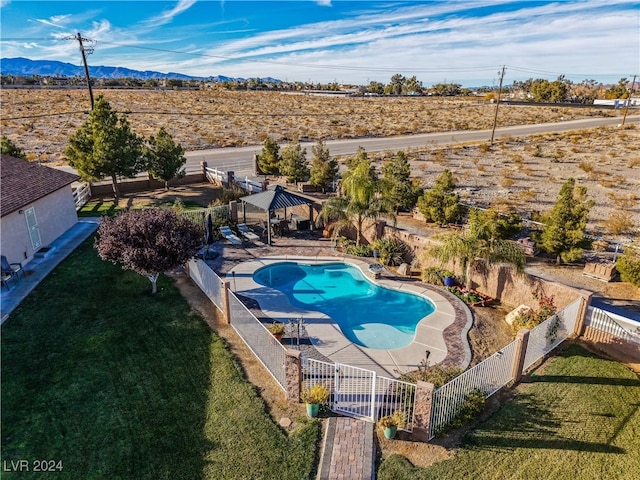 view of swimming pool featuring a gazebo, a mountain view, a yard, and a patio