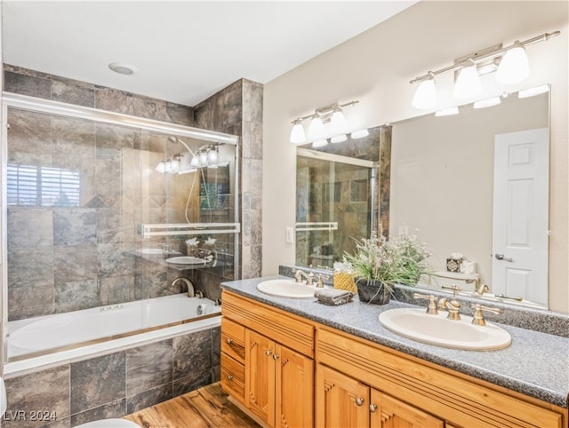 bathroom with vanity, combined bath / shower with glass door, and hardwood / wood-style flooring