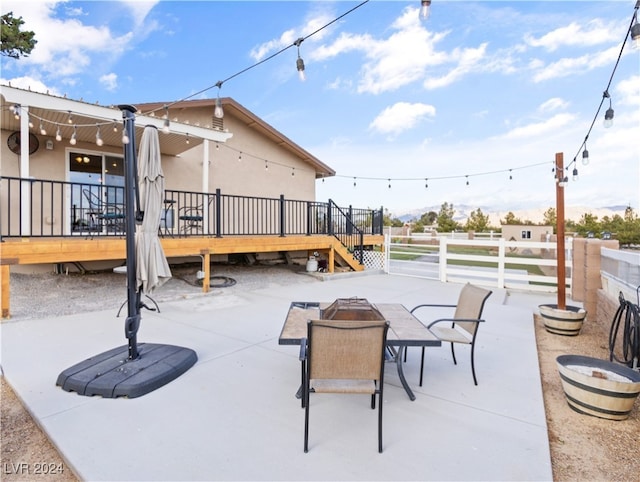 view of patio / terrace with a deck and an outdoor fire pit