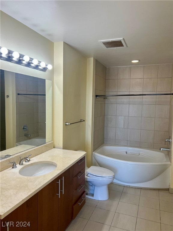 full bathroom with tile patterned flooring, vanity, toilet, and tiled shower / bath