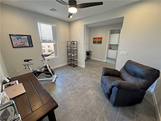 workout area with ceiling fan and light tile patterned flooring