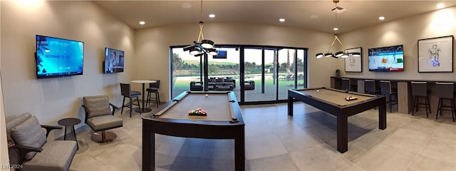 rec room with light tile patterned floors, a towering ceiling, and pool table