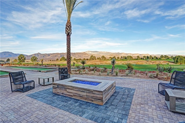 view of patio featuring a mountain view and a fire pit