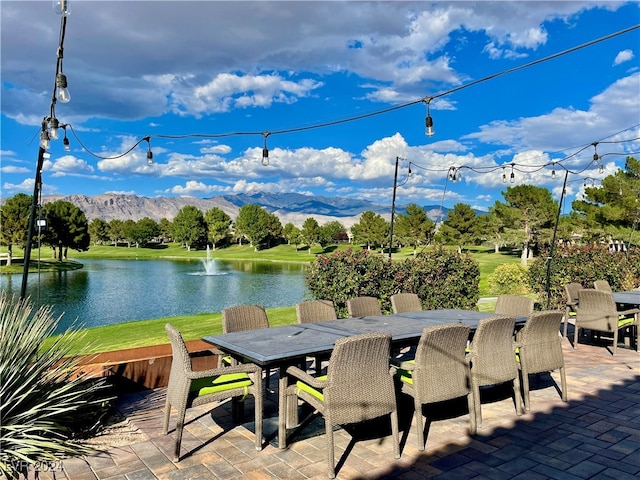 view of patio featuring a water and mountain view