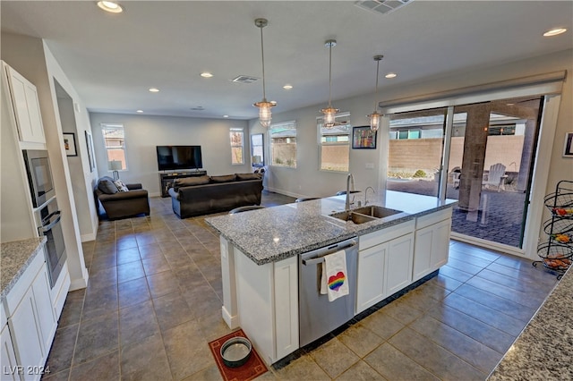 kitchen with white cabinets, stainless steel appliances, and plenty of natural light