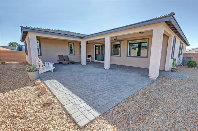 back of property featuring central AC unit, ceiling fan, and a patio