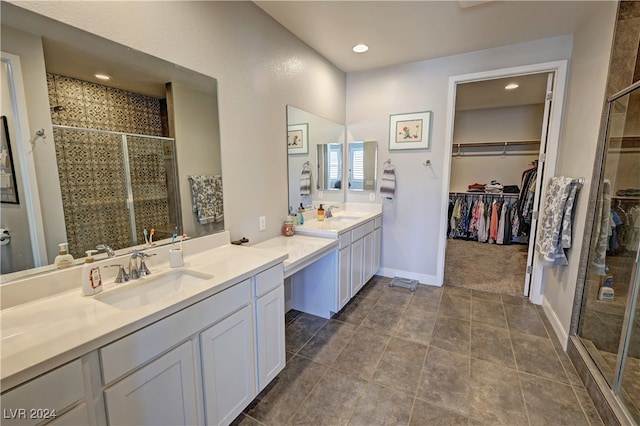 bathroom featuring tile patterned flooring, vanity, and walk in shower