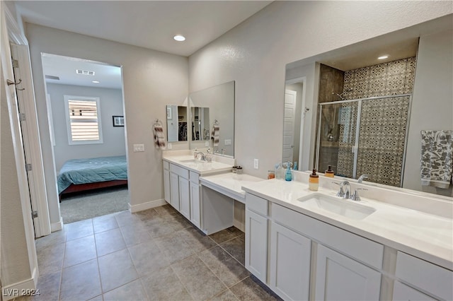 bathroom with vanity, tile patterned floors, and a shower with shower door