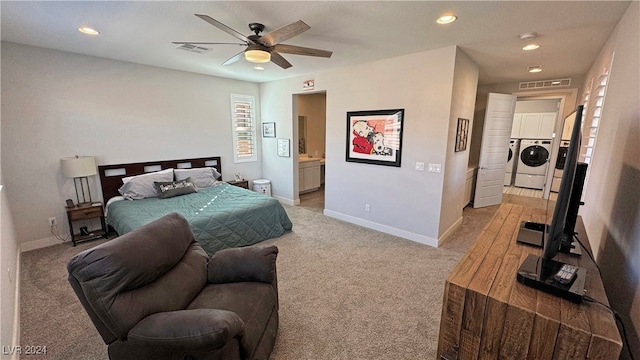 carpeted bedroom featuring ensuite bath, ceiling fan, and washing machine and clothes dryer