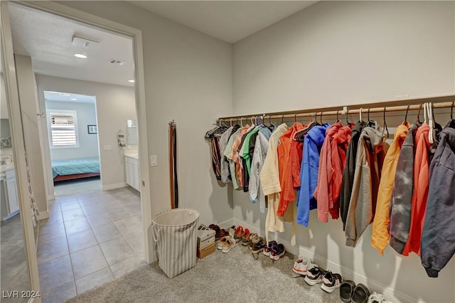 walk in closet featuring light tile patterned floors