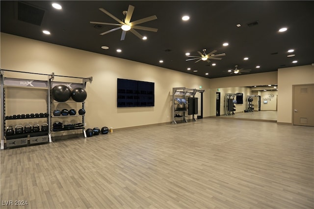 gym featuring light wood-type flooring and ceiling fan