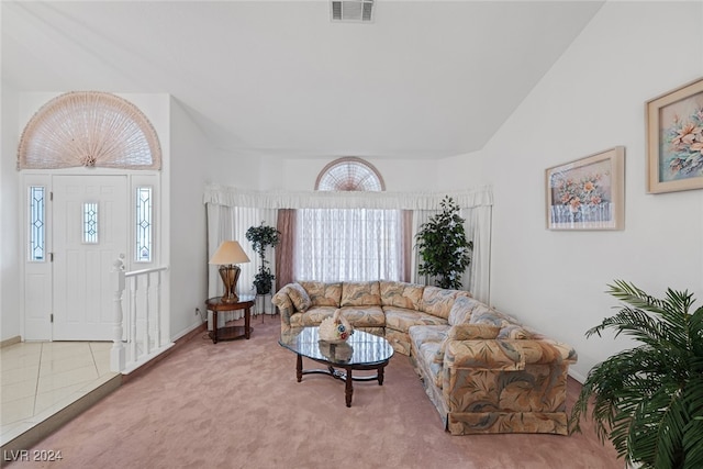 living room with carpet floors and high vaulted ceiling