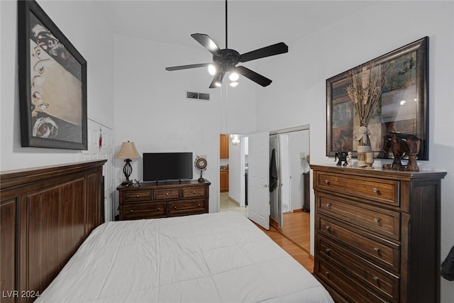 bedroom with ceiling fan, a closet, and high vaulted ceiling