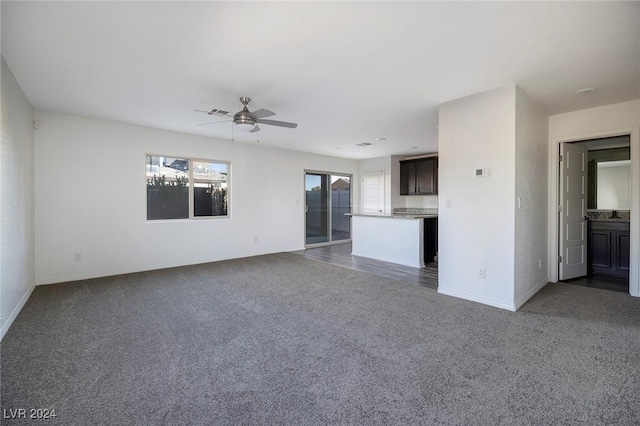 unfurnished living room with ceiling fan and carpet