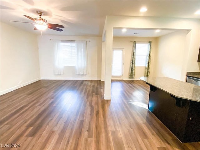 unfurnished living room featuring ceiling fan and hardwood / wood-style floors