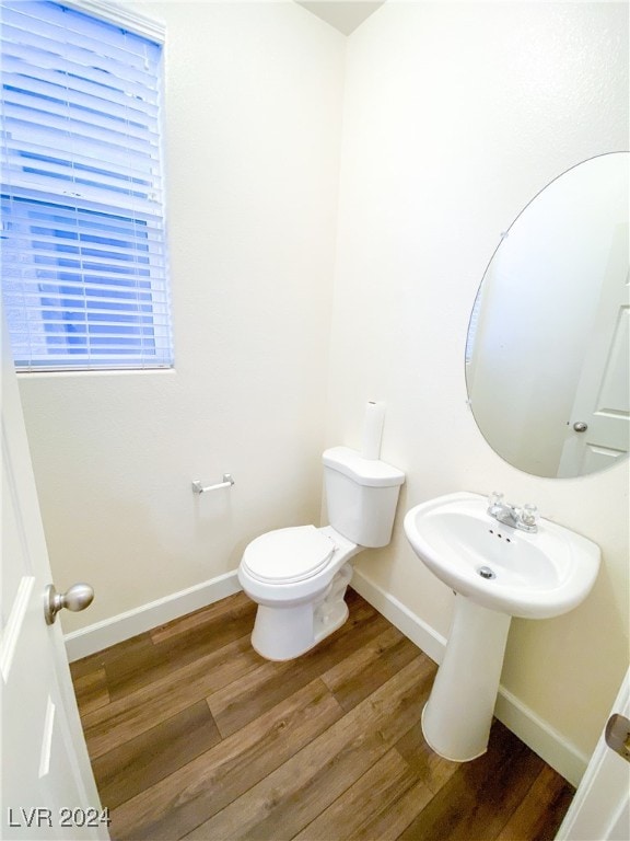 bathroom featuring hardwood / wood-style flooring and toilet