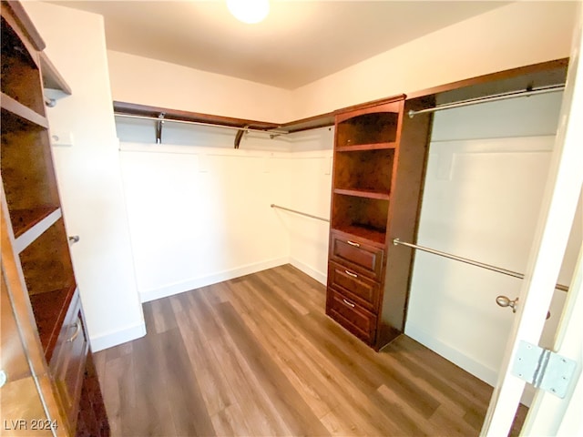 walk in closet featuring dark wood-type flooring