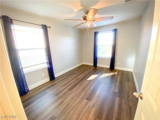 unfurnished room with dark hardwood / wood-style flooring and ceiling fan