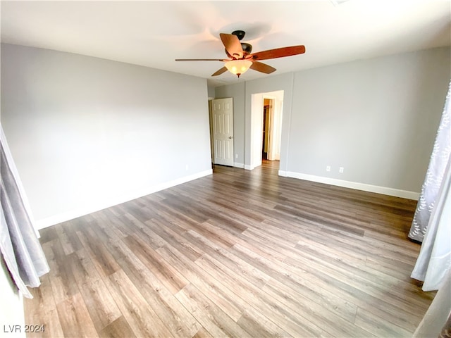 spare room with ceiling fan and light wood-type flooring