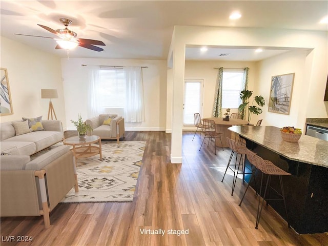 living room with hardwood / wood-style floors, ceiling fan, and a wealth of natural light