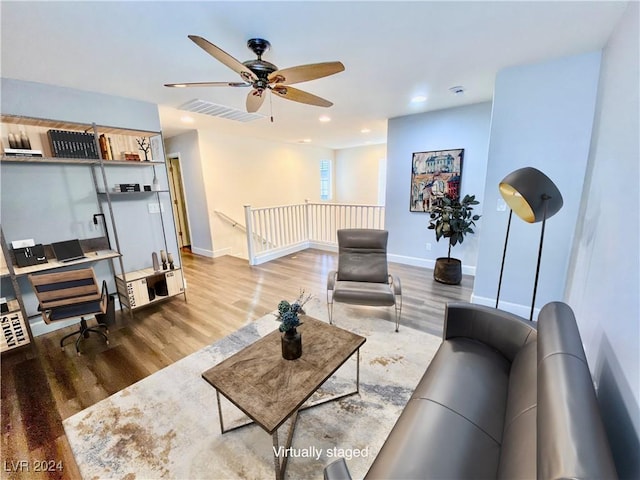 living room with hardwood / wood-style floors and ceiling fan