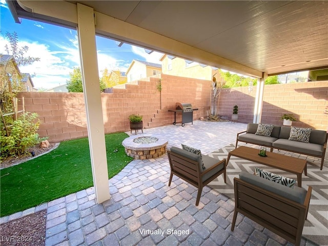 view of patio / terrace featuring area for grilling and an outdoor living space with a fire pit