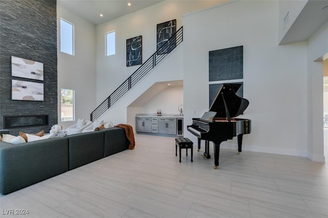 miscellaneous room featuring a towering ceiling and a fireplace