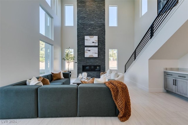 living room with a fireplace and a high ceiling