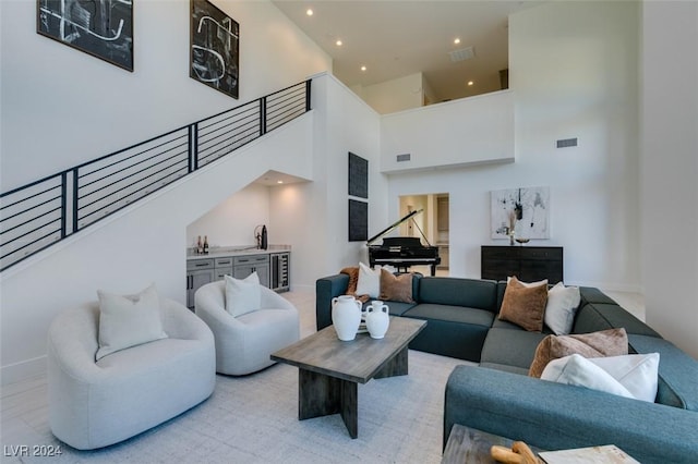 living room featuring a towering ceiling