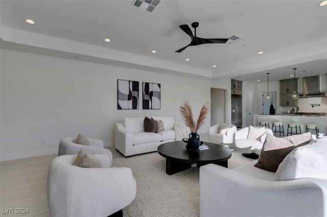 living room with ceiling fan and sink