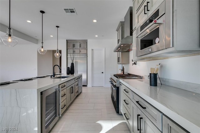 kitchen with appliances with stainless steel finishes, gray cabinetry, beverage cooler, sink, and pendant lighting