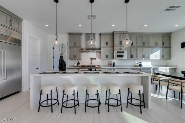 kitchen with a spacious island, hanging light fixtures, and appliances with stainless steel finishes