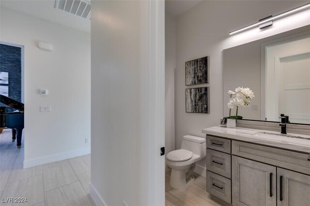 bathroom with tile patterned floors, vanity, and toilet