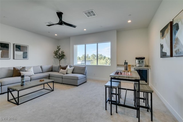 carpeted living room featuring ceiling fan and wine cooler