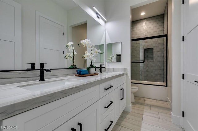 full bathroom with vanity, toilet, and enclosed tub / shower combo