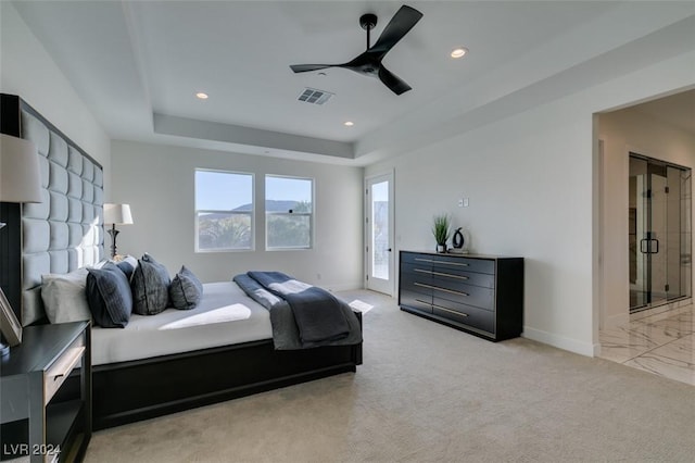 bedroom with light carpet, access to outside, a tray ceiling, and ceiling fan