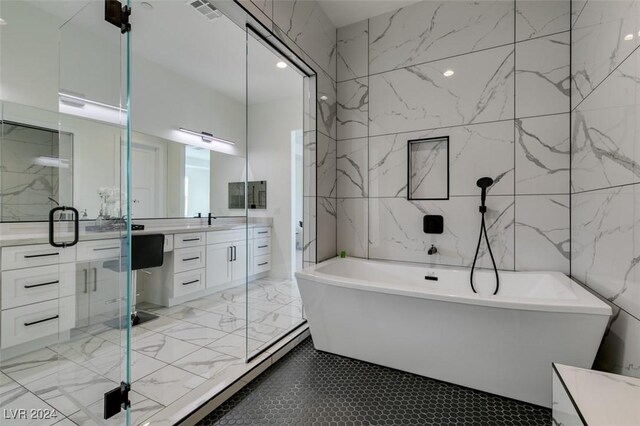 bathroom with vanity, tile walls, and shower with separate bathtub