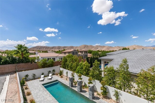 view of swimming pool featuring a mountain view and a patio area