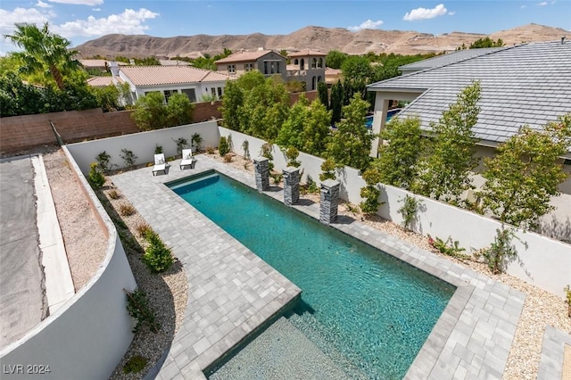 view of pool with a mountain view and a patio area