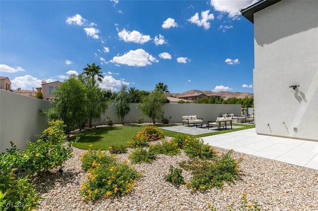 view of yard with outdoor lounge area and a patio