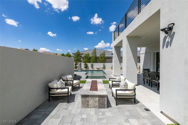 view of patio featuring outdoor lounge area and a fenced in pool