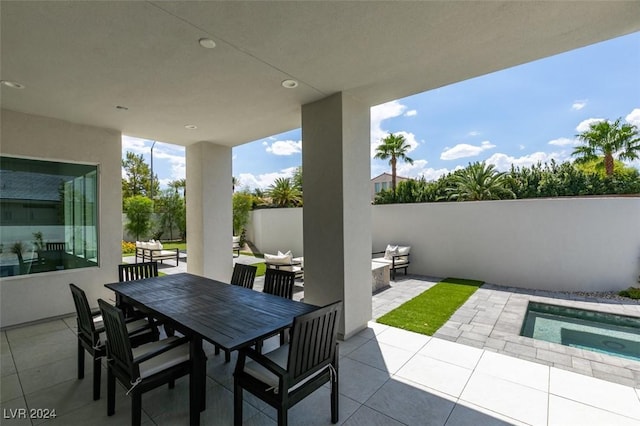 view of patio / terrace with a pool with hot tub