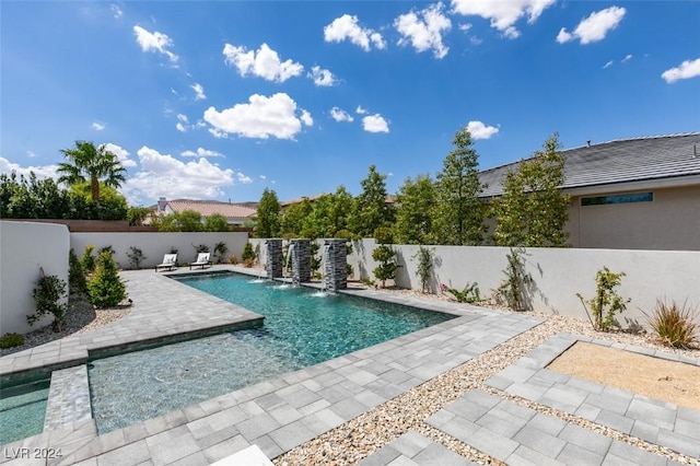 view of swimming pool featuring pool water feature and a patio