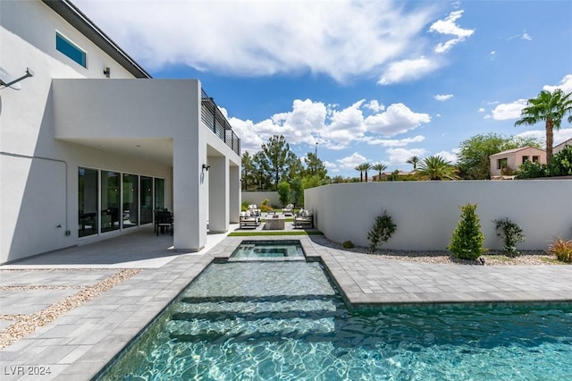 view of swimming pool with an in ground hot tub and a patio