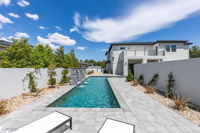 view of swimming pool featuring a patio area and pool water feature