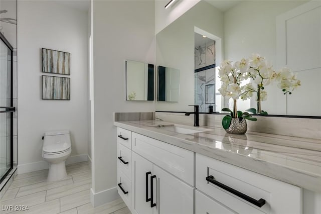 bathroom with vanity, toilet, and walk in shower